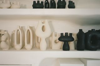 Cream and black sculptures on shelves