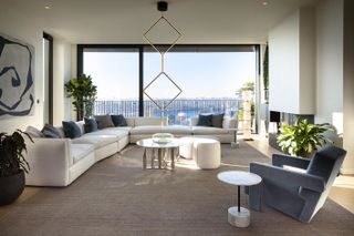 Living room with white L-shaped lounge suite and a stunning view of the city