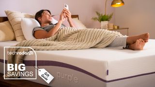A woman lies on a Purple PLus mattress in a bedroom, looking at her phone