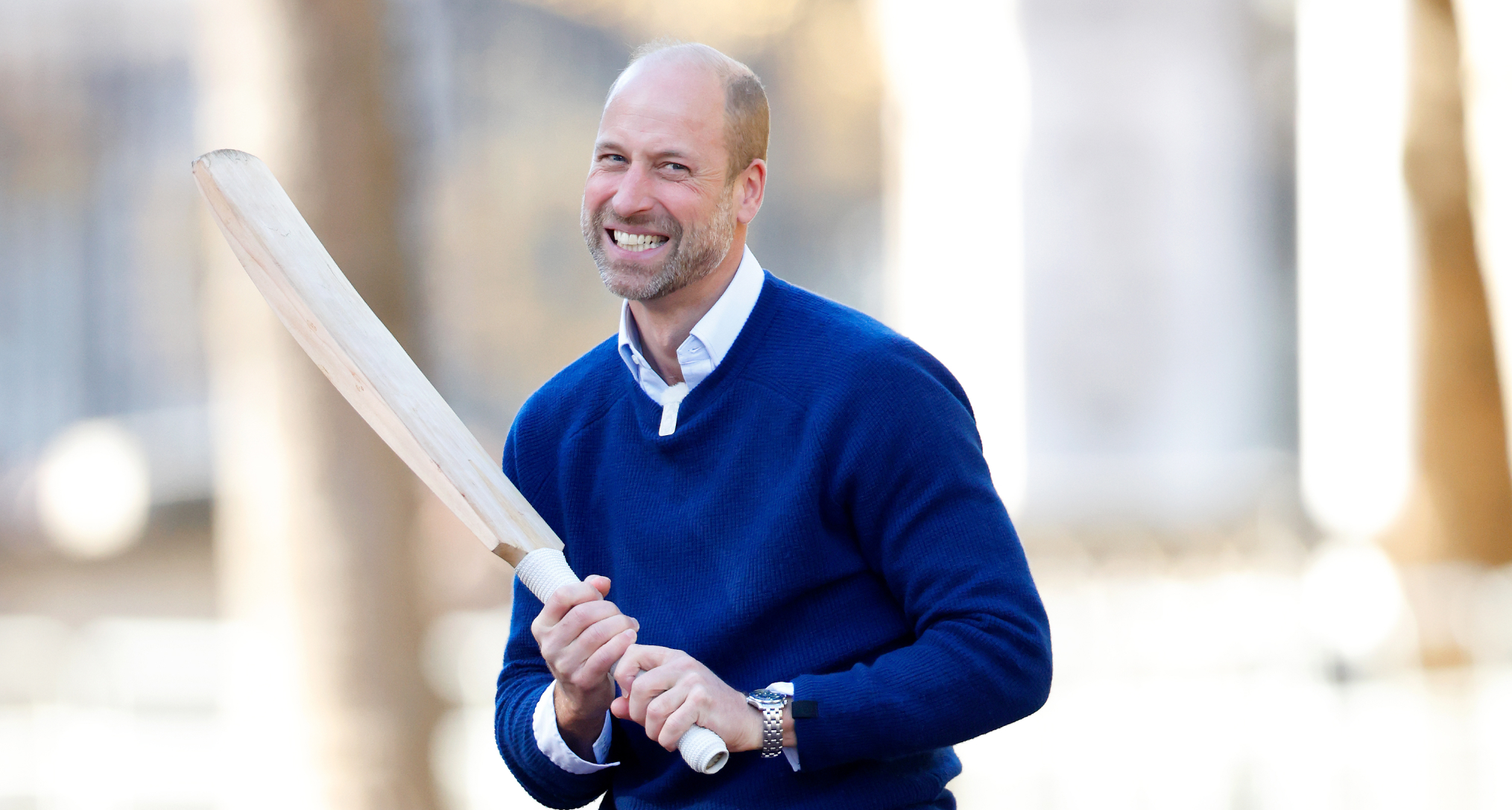 Prince William holding a cricket bat