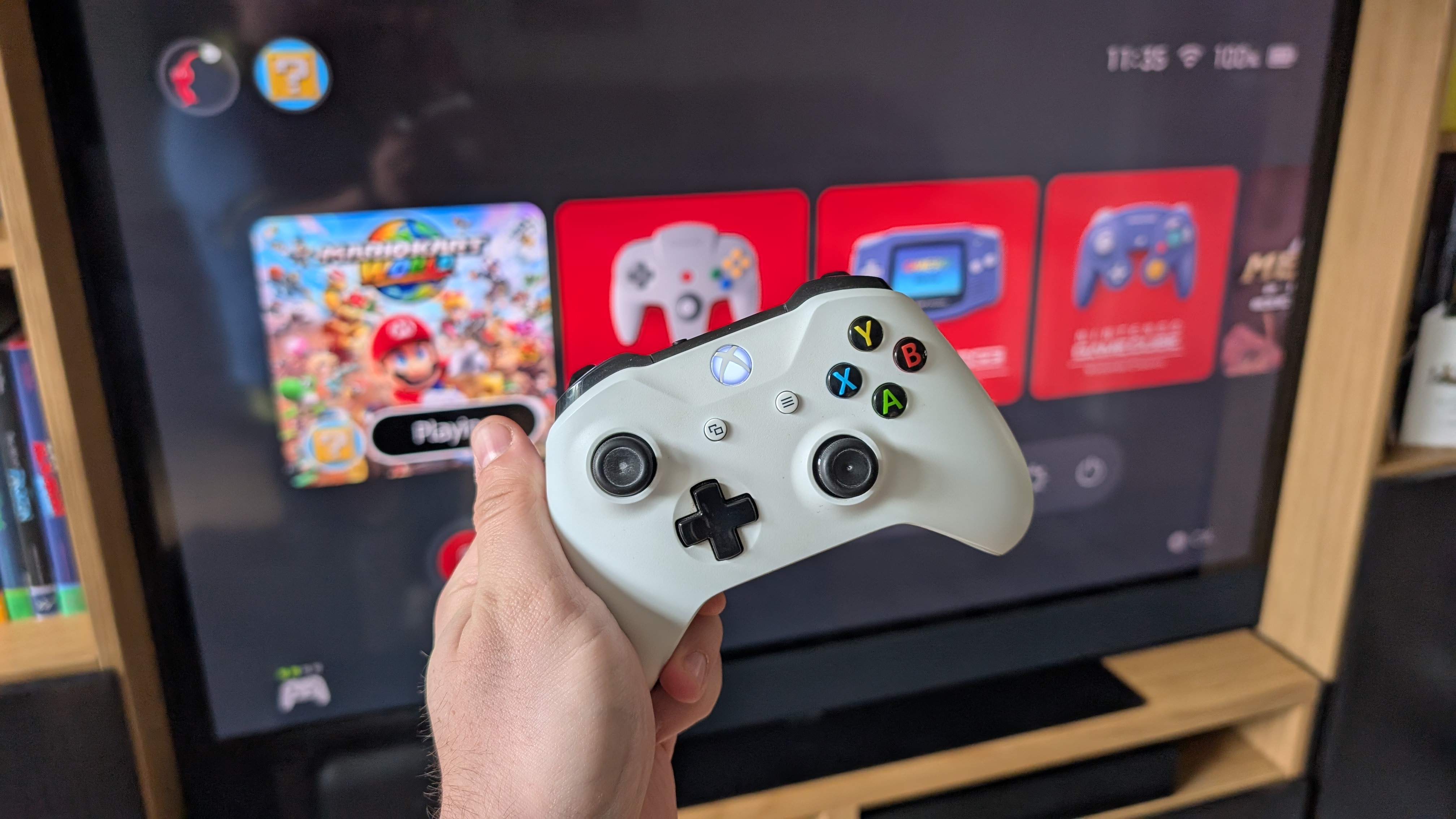 xbox one s controller in front of tv showing switch 2 home screen