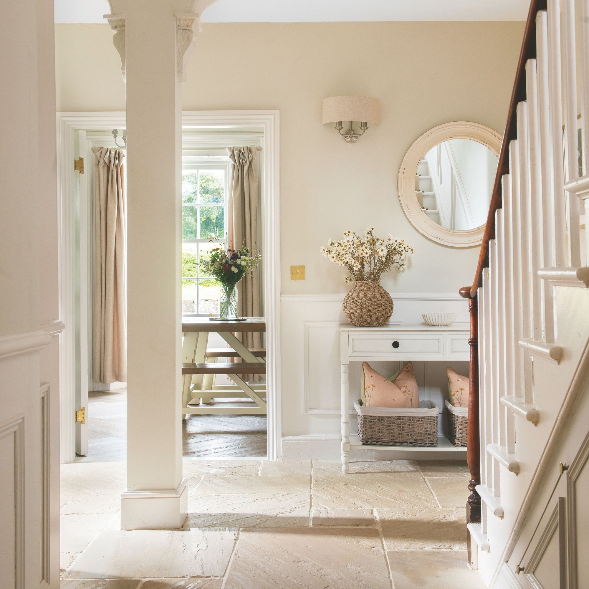 Hallway in cottage with stone floor, staircase and lots of light