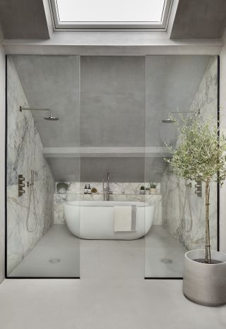 An example of spa bathroom ideas showing a loft space with gray walls, glass doors and marble with chrome fittings