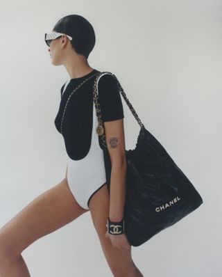 Model carries Chanel beach bag