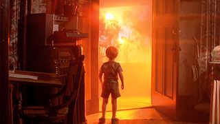 A little boy staring at a bright orange light outside of his house in "Close Encounters of the Third Kind"