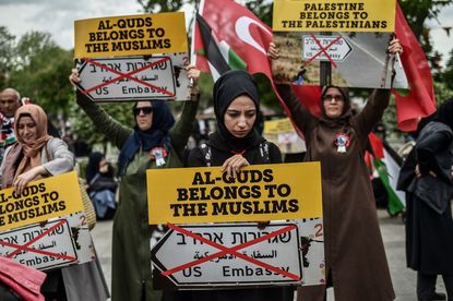 Women protestors hold placards reading 'Al Quds belongs to muslims' on May 11, 2018 in Istanbul, during a demonstration against US President Donald Trumps controversial decision to recognise 