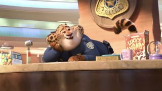 Nate Torrence as Officer Benjamin Clawhauser leaning on his desk in Zootopia