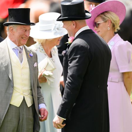 King Charles laughing and talking to Zara Tindall and Mike Tindall at Royal Ascot
