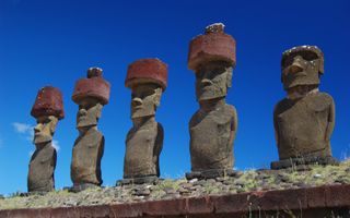 Moai with red topknot hats at Anakena Ahu Na in Chile, Easter Island.