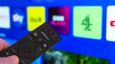 UK TV apps with remote control pointing at the TV
