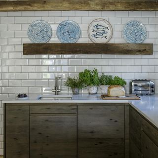 kitchen area with tiles and marble counters