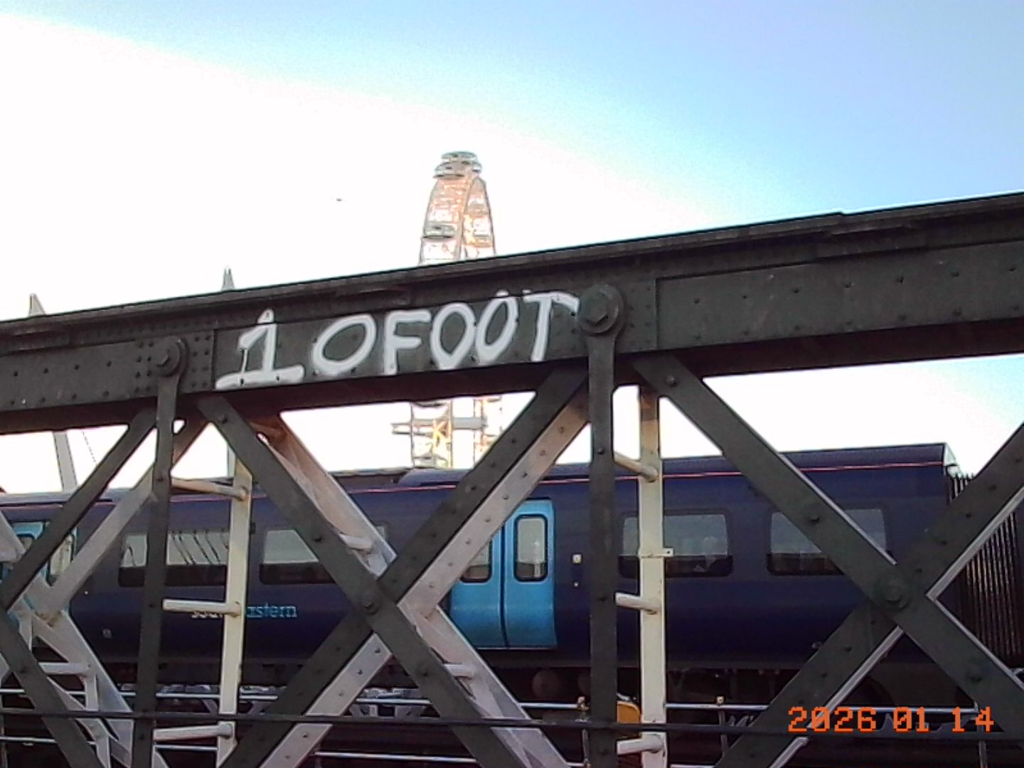 Kodak Charmera sample gallery: grafittied railway with the London Eye behind it