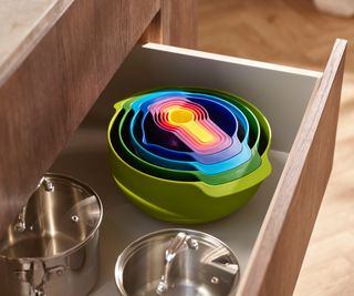deep kitchen drawer with multi-colour bowls nested inside one another