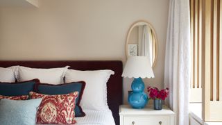 Blue lamp with scalloped edge in bedroom