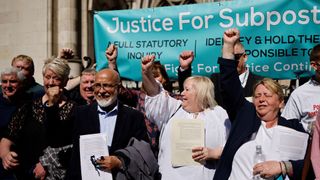 Former subpostmasters celebrate outside the Royal Courts of Justice in London, on April 23, 2021, following a court ruling clearing subpostmasters of convictions for theft and false accounting.