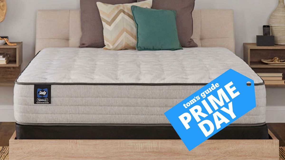 Sealy Posturepedic Spring Bloom mattress on a wooden bed frame in a neutral bedroom with a Tom&#039;s Guide Prime Day deal badge laid over the image 