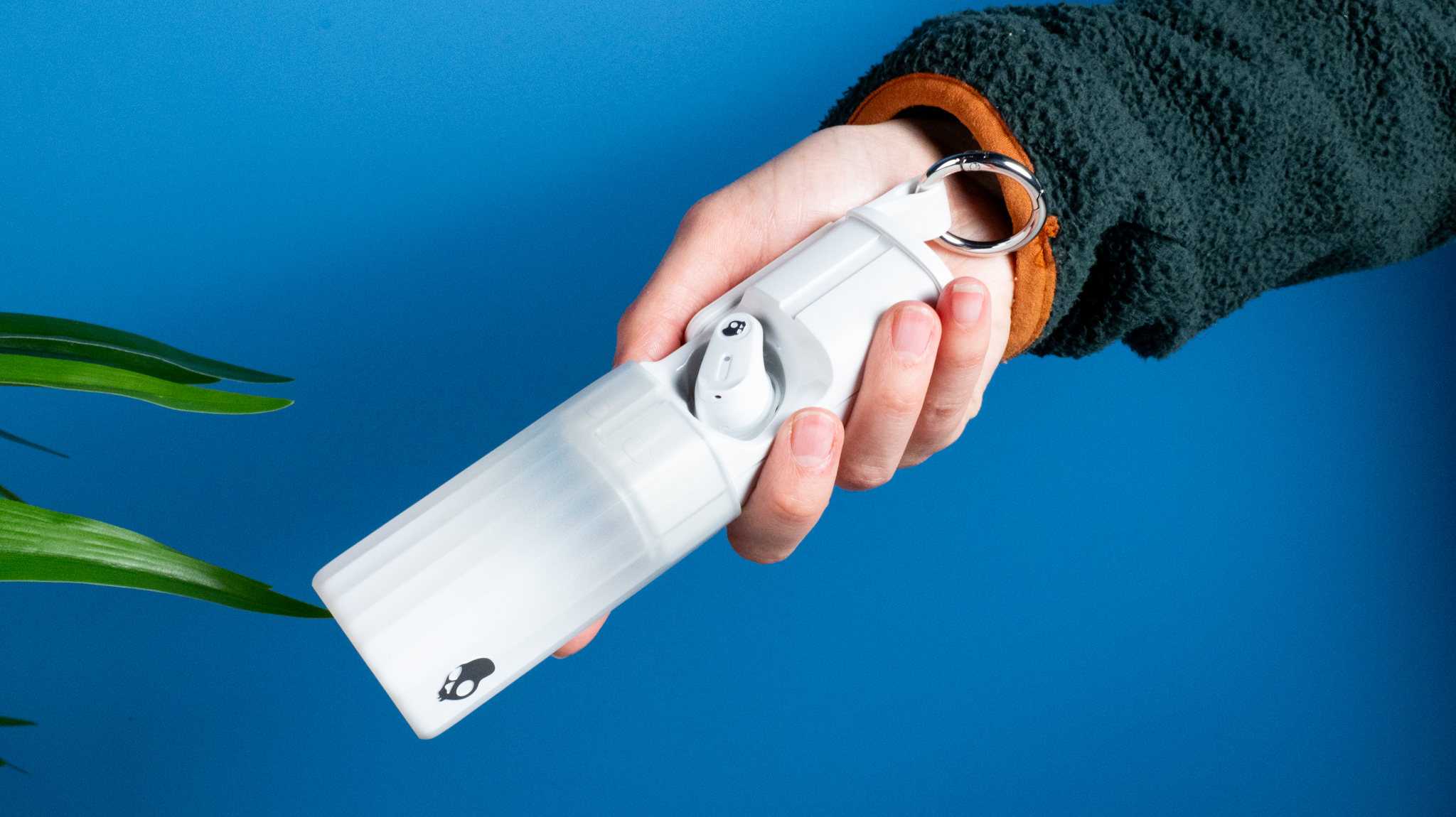 the skullcandy x bose method 360 anc earbuds in white, with a long charging case, a carabiner clip, and various silicone tip sizes