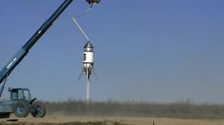 The suborbital Xaero launch vehicle built by Masten Space Systems performs a tethered flight test on Feb. 21, 2011 in this still from a video by Masten officials.