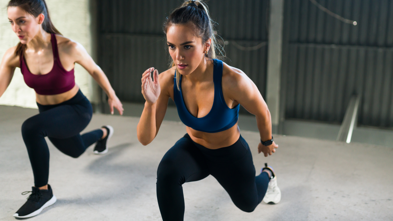 Two women doing bodyweight lunges