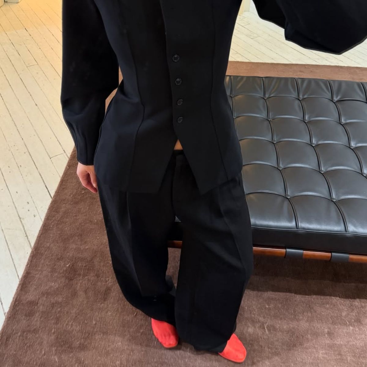 @mimixn wears red mesh flats with black trousers and a black blazer 