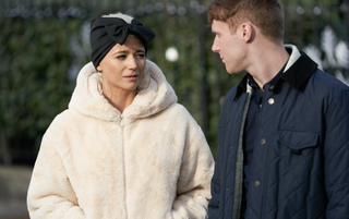 EastEnders star Danielle Harold wearing a big white coat with a headband