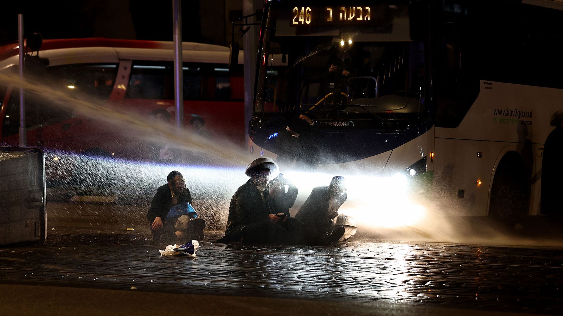 
                                Israeli police deploy water cannons against seated ultra-Orthodox Jews peacefully protesting Israel's military recruitment law in Jerusalem, Israel
                            