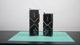 The Nvidia RTX 4070 and RTX 3080 pictured together on a green worksurface.