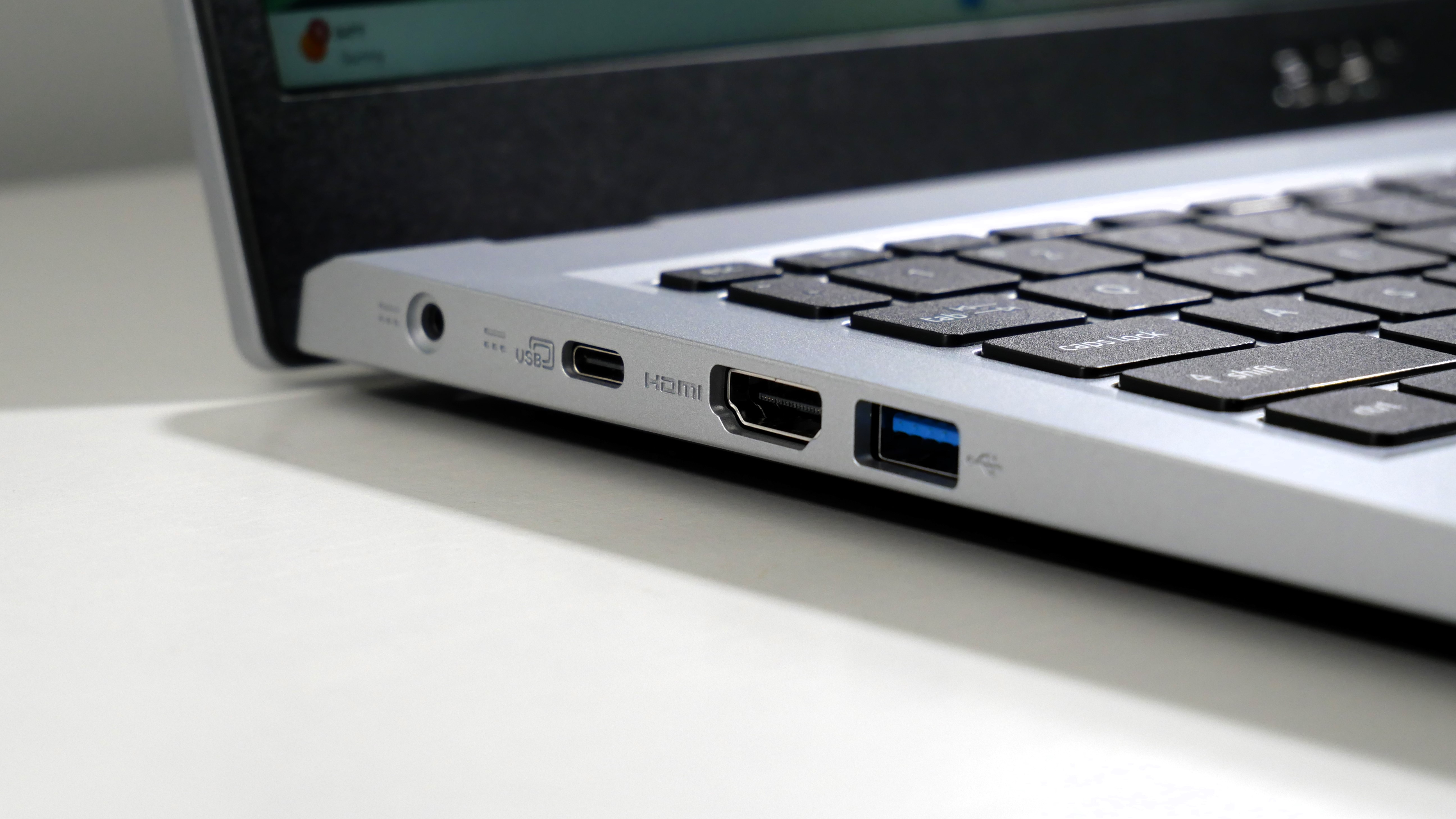 Acer Aspire 3 15 open on a white desk, highlighting the ports on the left.