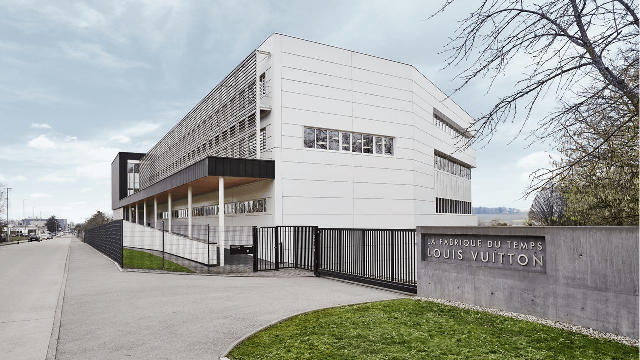 white building with grass in front: La Fabrique du Temps Louis Vuitton building in Geneva, Switzerland