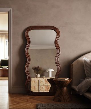 Neutral bedroom with sculptural mirror