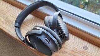 The Bose QuietComfort 45 headphones lying on a windowsill