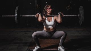 Woman squatting with a barbell