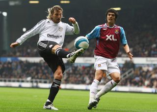 LONDON - APRIL 19: Robbie Savage of Derby County hooks in a cross watched by James Tomkins of West Ham United during the Barclays Premier League match between West Ham United and Derby County at Upton Park on April 19, 2008 in London, England. (Photo by Jamie McDonald/Getty Images)