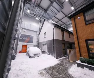 Two prototype houses in a warehouse