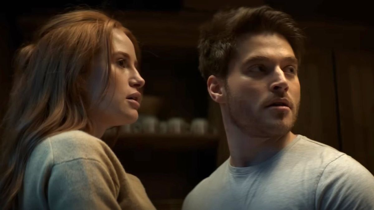 Madelaine Petsch as Maya and Froy Gutierrez as Ryan look toward a noise in a screenshot from the trailer of The Strangers: Chapter 1.