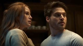 Madelaine Petsch as Maya and Froy Gutierrez as Ryan look toward a noise in a screenshot from the trailer of The Strangers: Chapter 1.