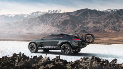 Audi activesphere concept in snowy mountainous terrain with bike on back