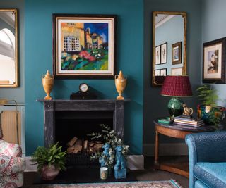 Living room decorated in a moody color palette with pops of more vibrant colors introduced via decorative items