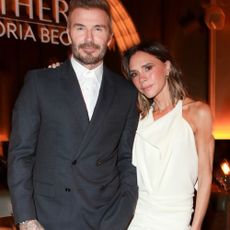 Victoria Beckham wears a draped dress.