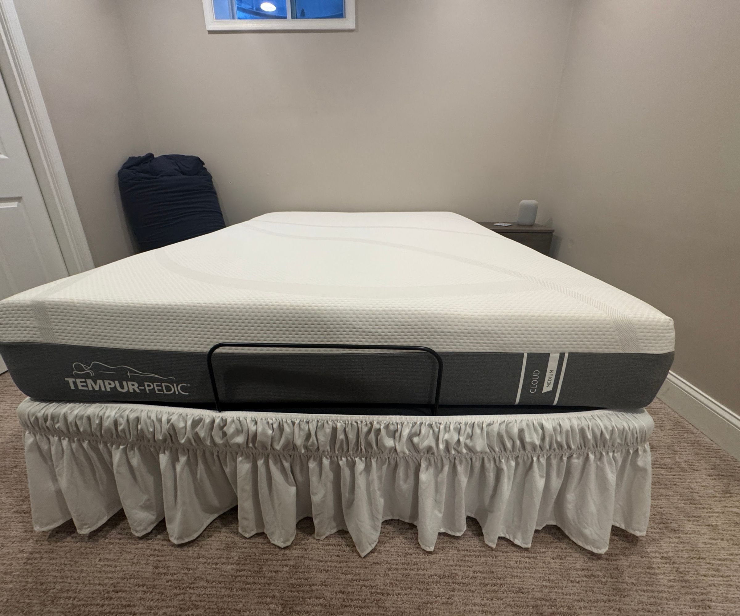 TEMPUR-Cloud Mattress on a bed base against white walls.