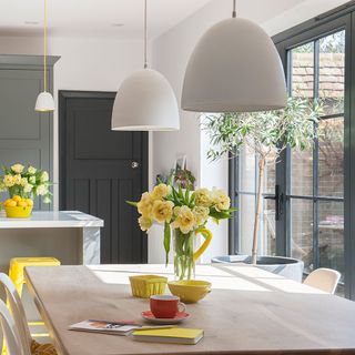 white kitchen with dining table and white kitchen worktop