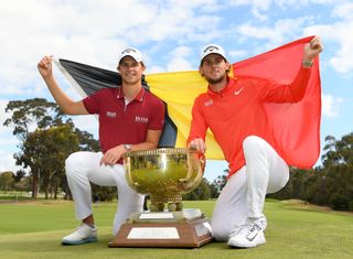 Thomas Detry and Thomas Pieters with the World Cup of Golf and a large Belgian flag in 2018