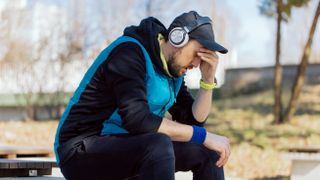 Unhappy man wearing fitness tracker