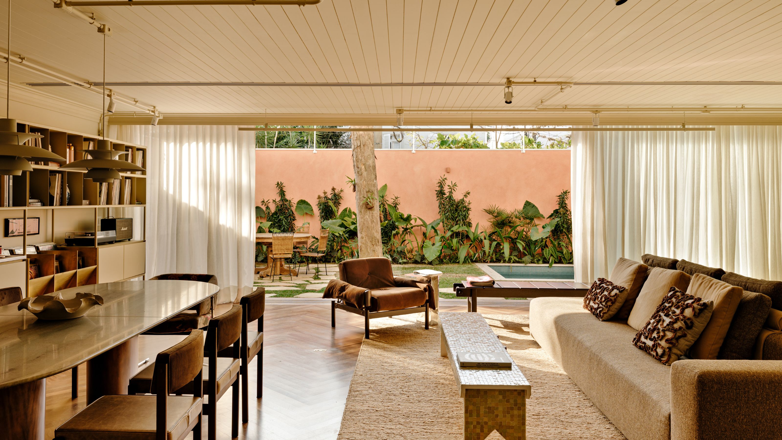 A dining cum living room connected to an outdoor space 