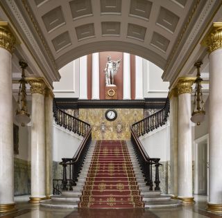 The Athenaeum - Waterloo Place - London SW1. The main stair, with its copy of the Apollo Belvedere. The column capitals echo those of Athens' Tower of the Winds. Photograph: Will Pryce/Country Life Picture Library.