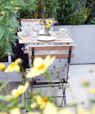 folding table and chairs on a balcony garden
