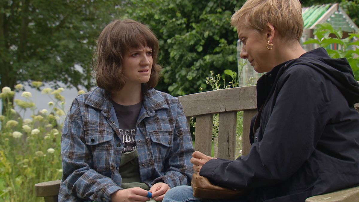 Gail looks confused while sitting on a bench in Emmerdale 