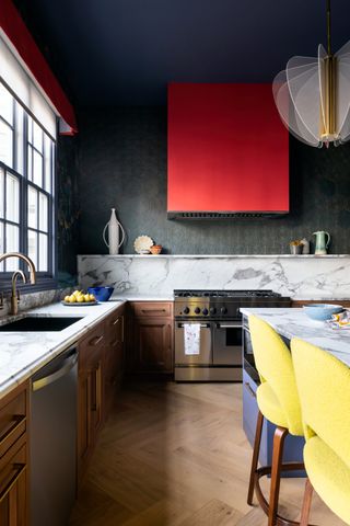a kitchen with a red cooker hood
