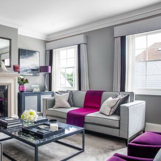 Grey living room with sofa and windows dressed with matching curtains and pelmet