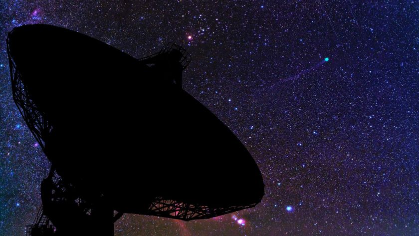 a large radio dish under a starry sky